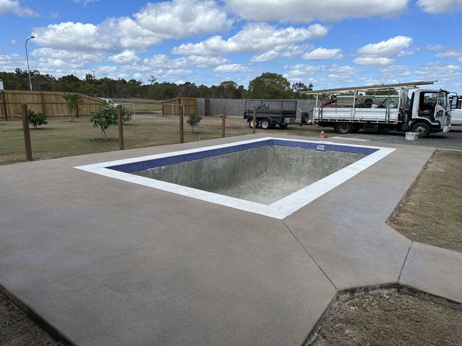 A finished pool surround with a concrete apron at a Bundaberg home