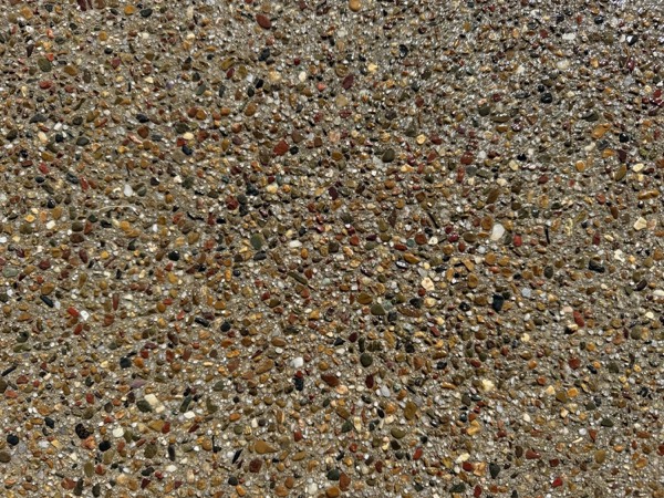 A close-up of a washed exposed aggregate finish showing the pebble colours