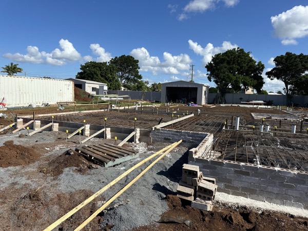Formed and pegged footings across a cleared house block