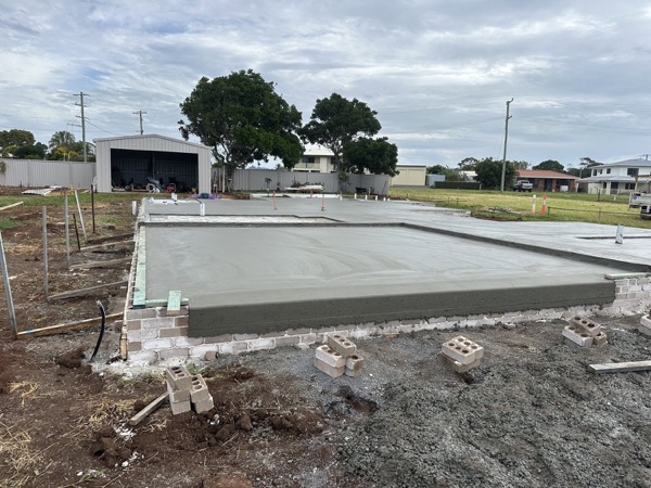 A poured concrete slab sitting in its timber formwork