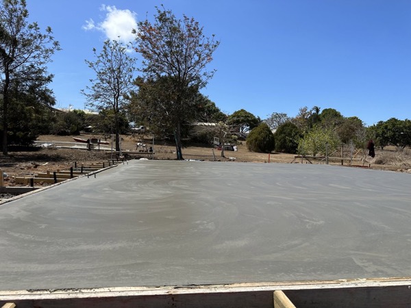 A large fresh slab among trees with timber formwork at the edge