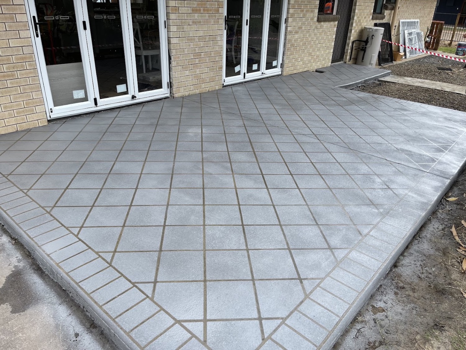 A patterned concrete path scored in a diamond pattern